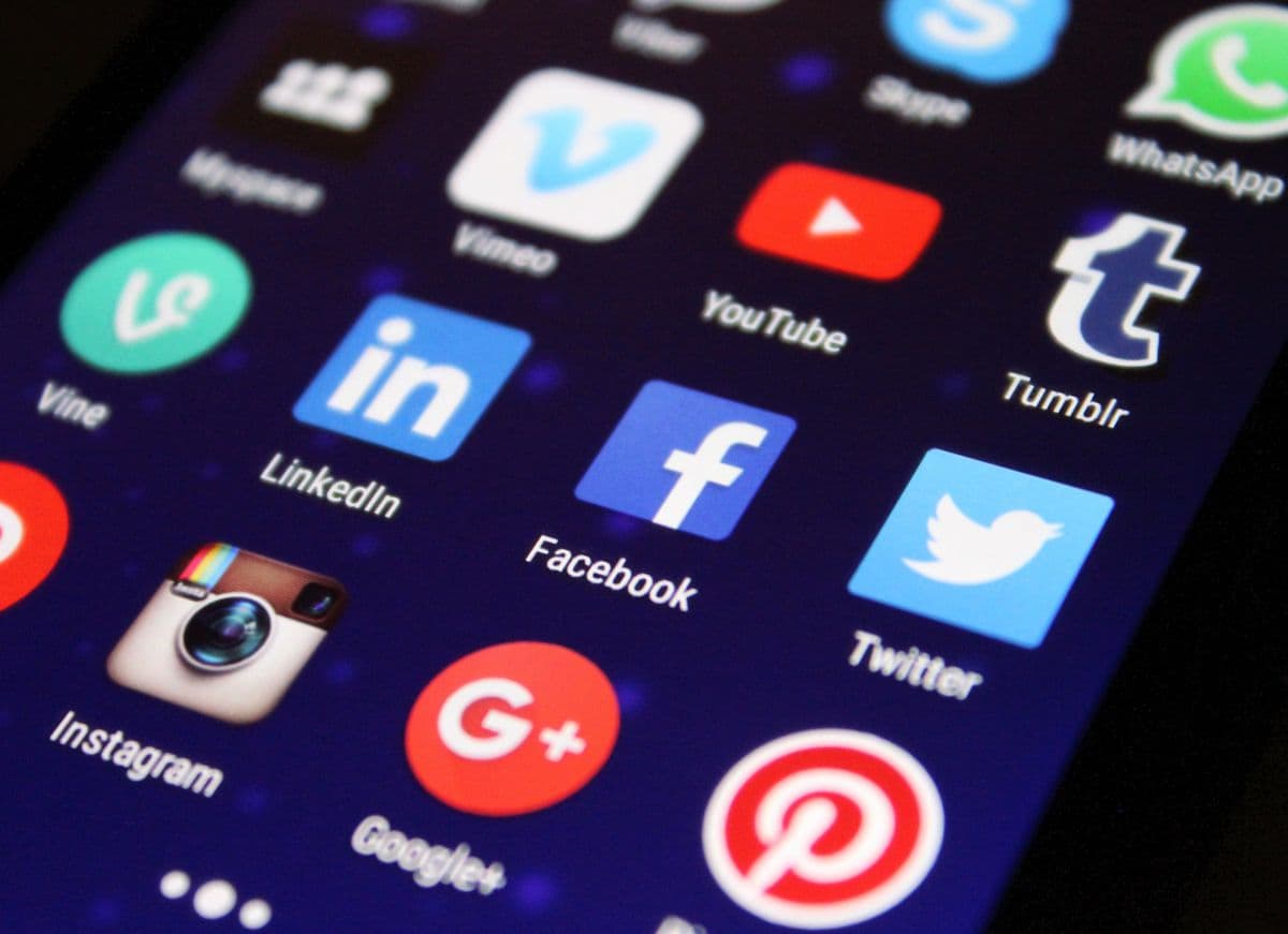Phone showing a social media feed on a desk